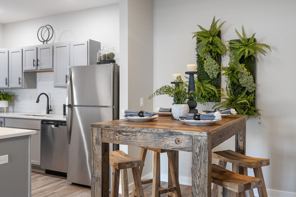 a kitchen with stainless steel appliances and a wooden table