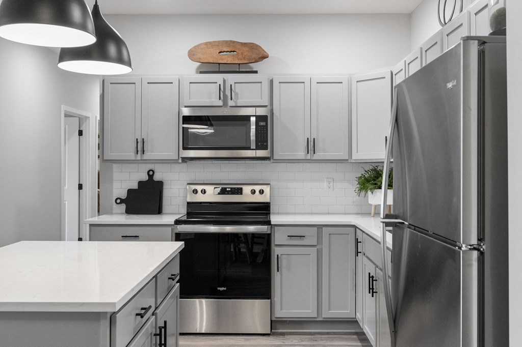 a kitchen with stainless steel appliances and white cabinets