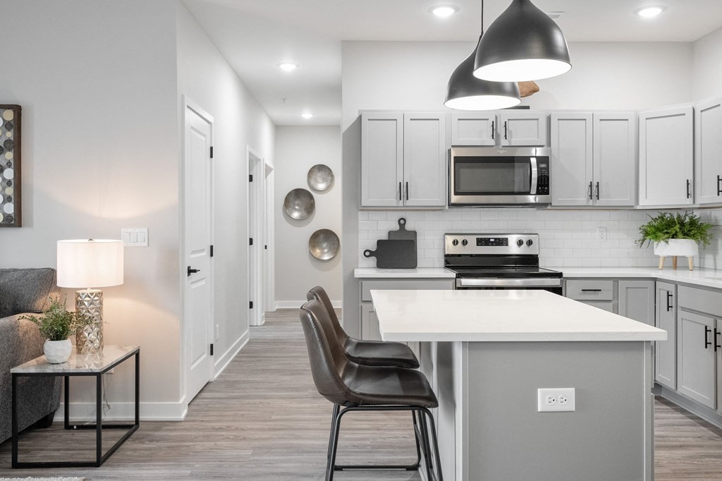 a kitchen with white cabinets and a white counter top