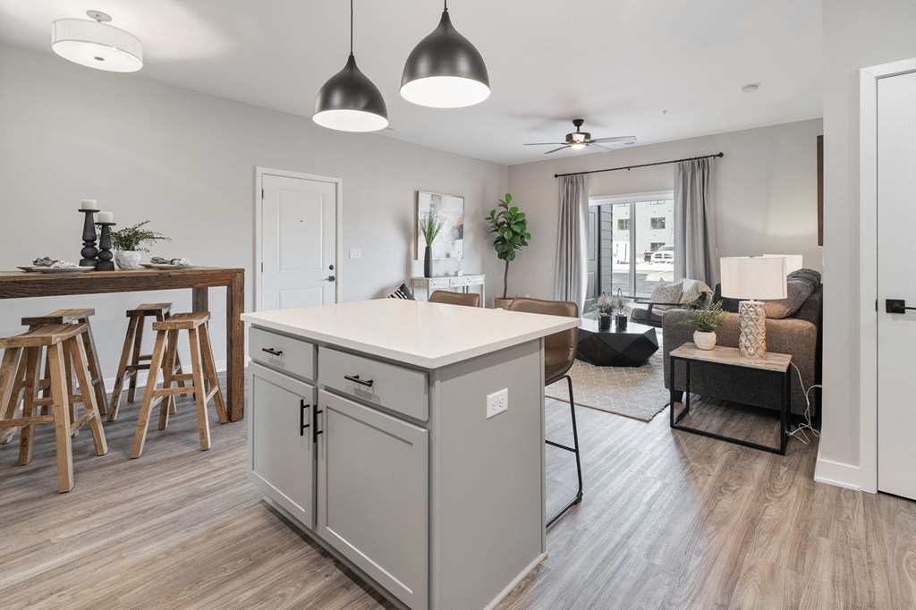 an open living room and kitchen with an island in the middle