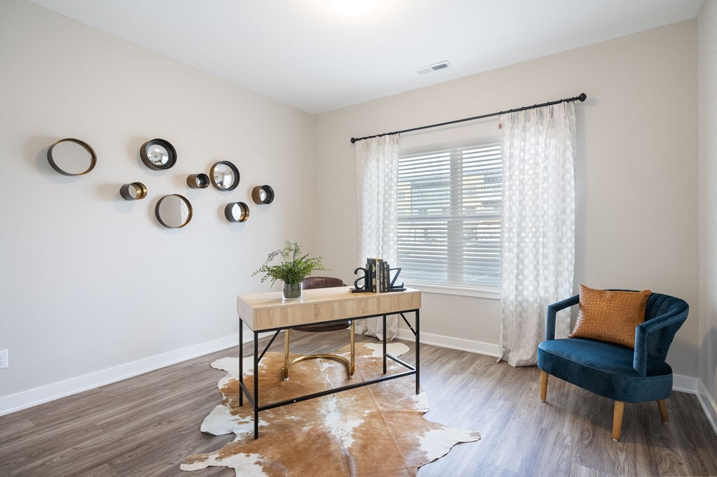an office with a large window and a desk with a chair
