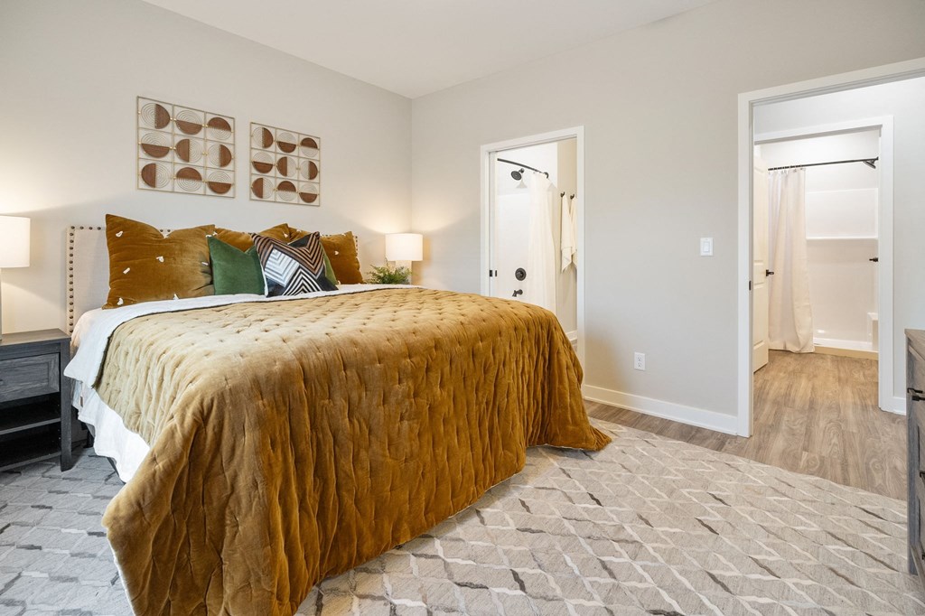 a bedroom with a bed and a door to a bathroom