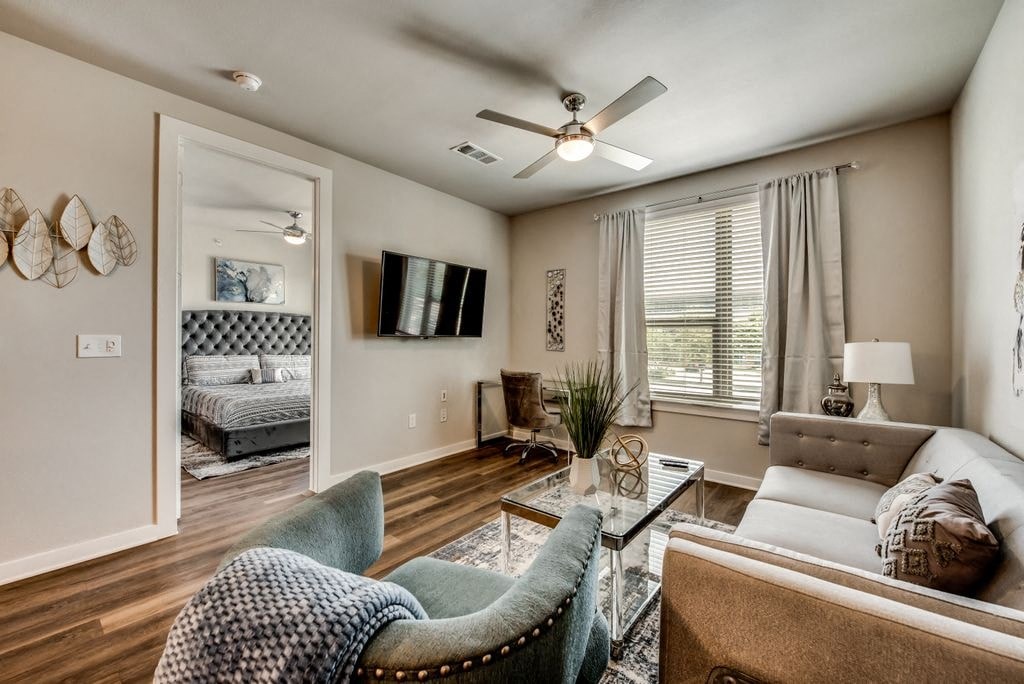 a living room with a couch and a ceiling fan