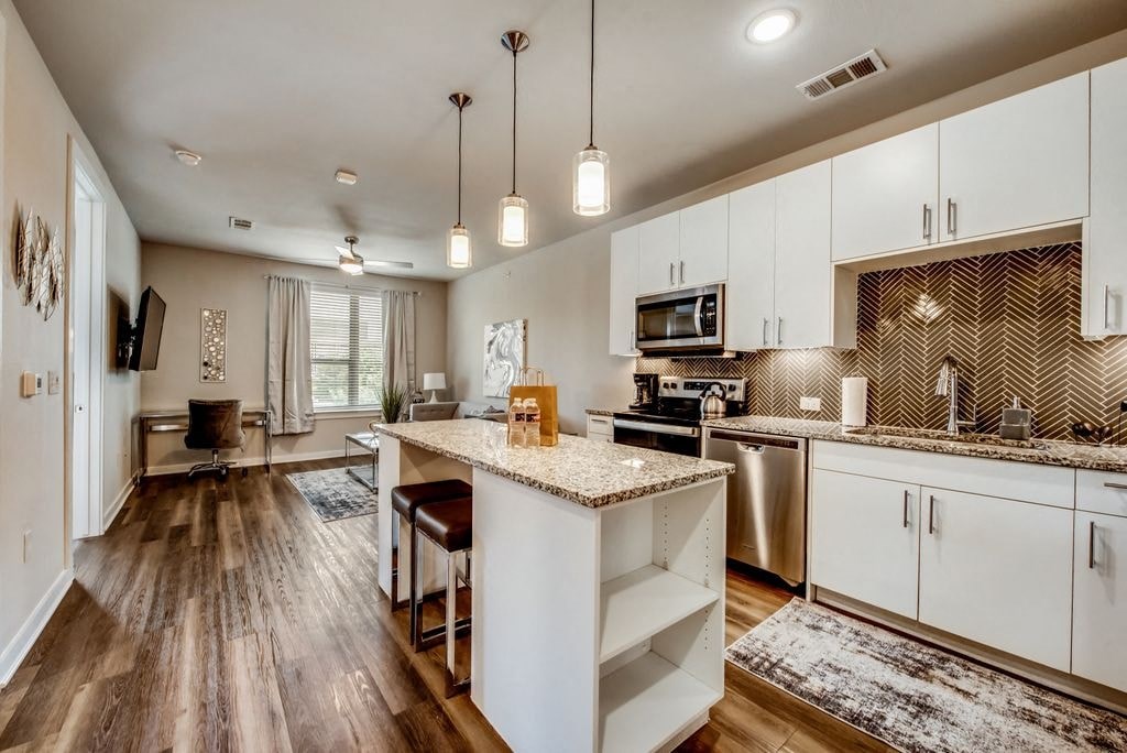 an open kitchen and living room with a counter top
