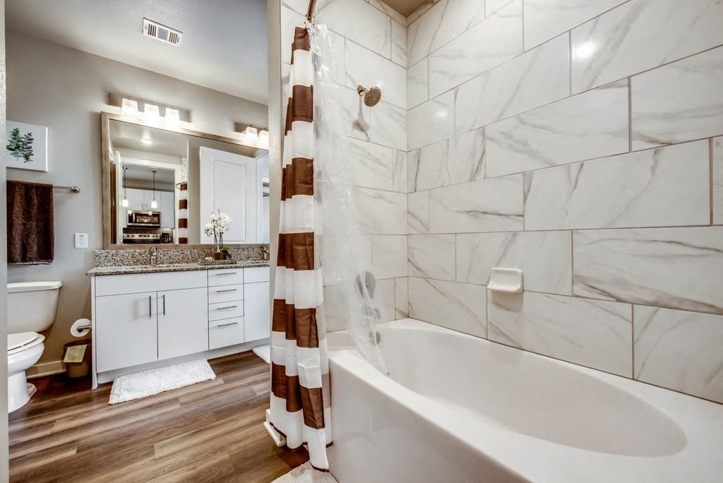 a bathroom with a tub and a sink and a toilet