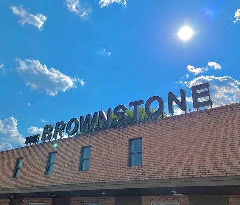 the sign for brownstone on top of a brick building