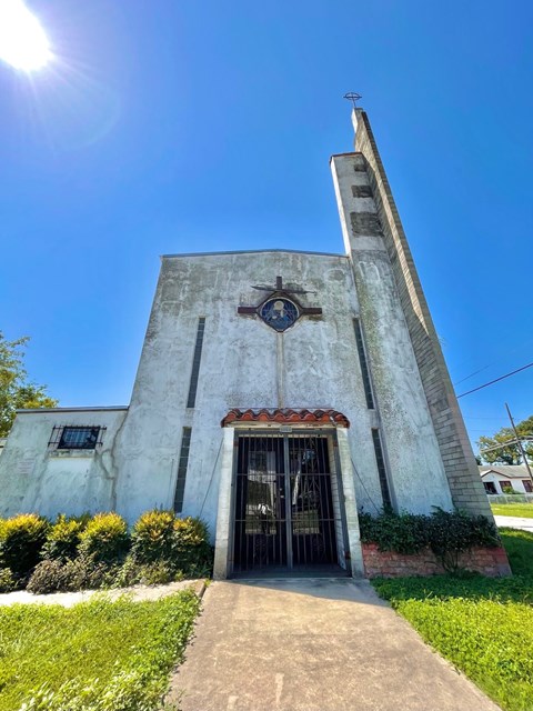 a church with a tall tower and a clock on it
