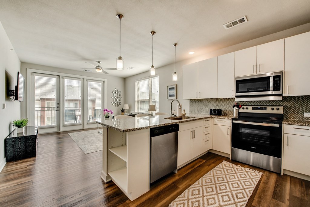 a kitchen with white cabinets and a counter top