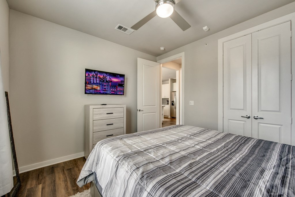 a bedroom with a bed and a ceiling fan
