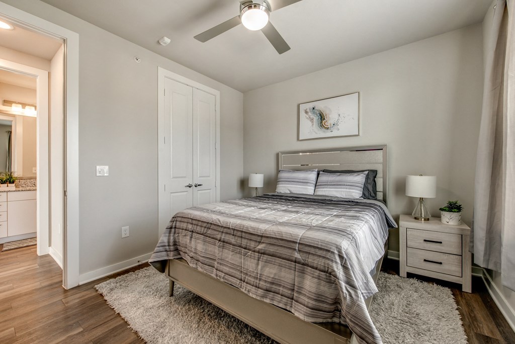 a bedroom with a bed and a ceiling fan