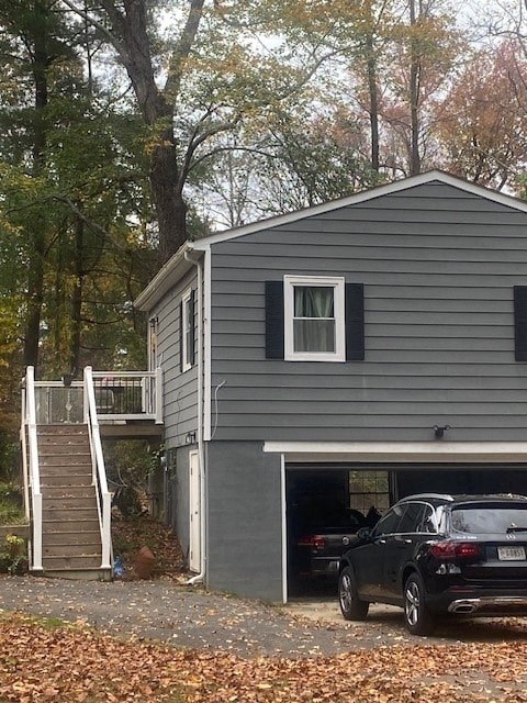 a gray house with a car parked in a garage