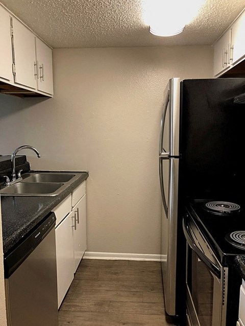 a kitchen with a sink and a refrigerator