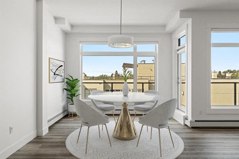 A dining room with a white table and chairs, a gold vase, and a large window.