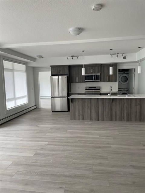 A modern kitchen with wooden cabinets and a large island.