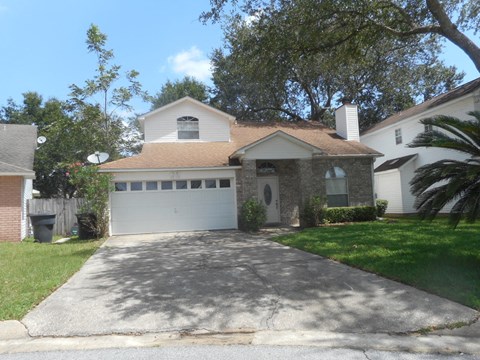 a house with a driveway and a white garage door