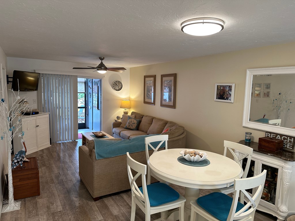 a living room and dining room with a white table and chairs