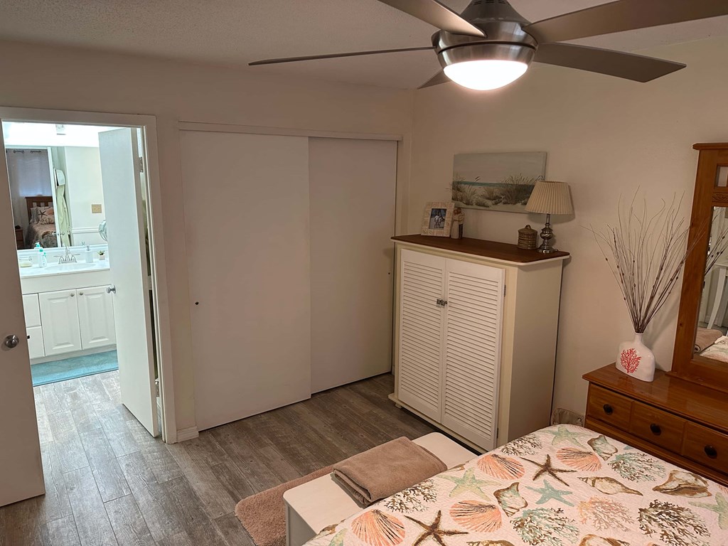 a bedroom with a bed and a ceiling fan