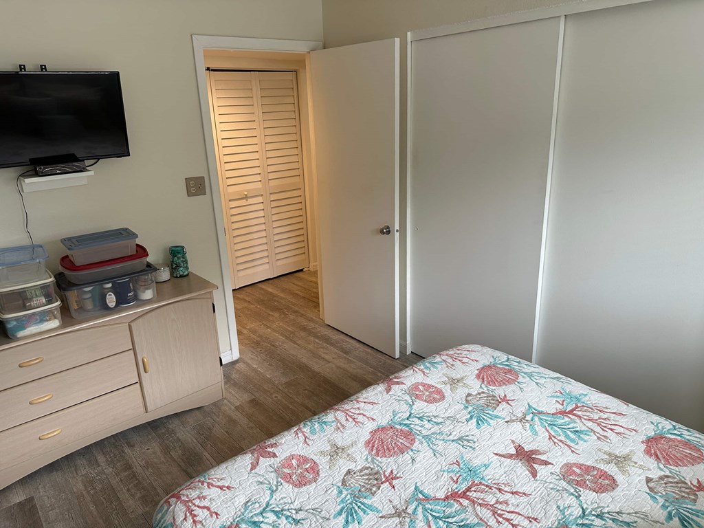 a bedroom with a bed and a tv