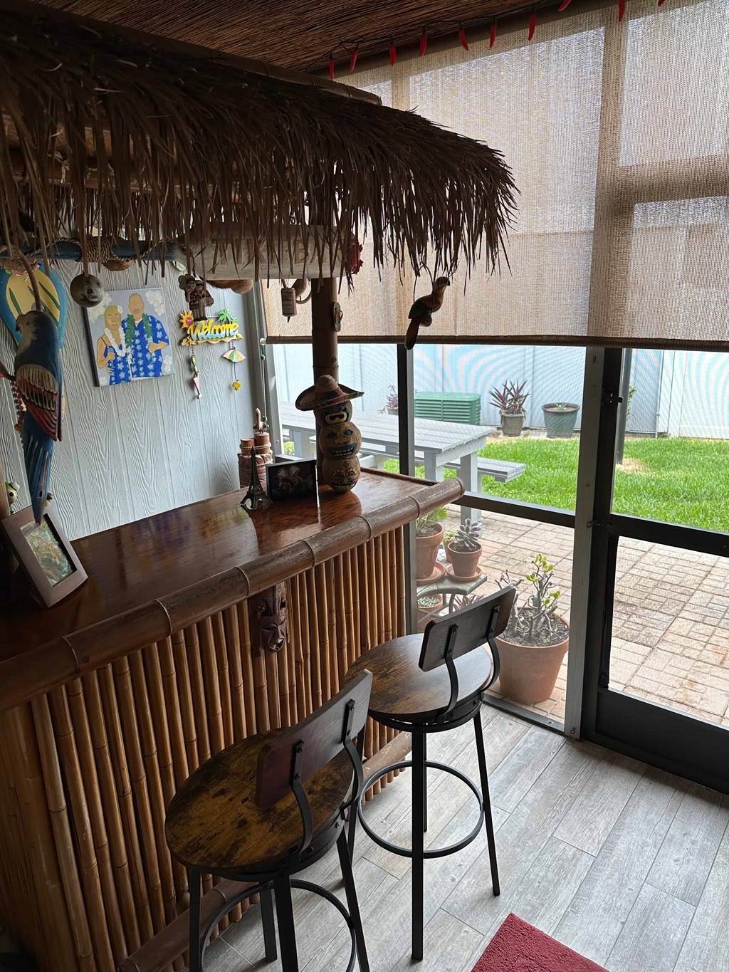 a bar with two stools in front of a window