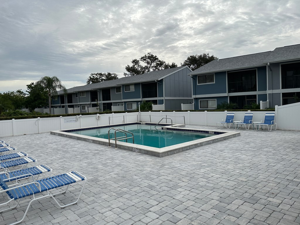 our apartments have a resort style pool and lounge chairs