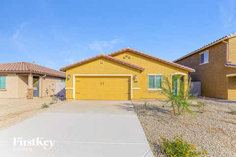 a yellow house with a yellow garage door