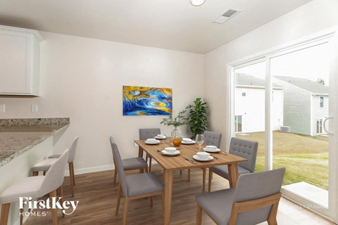 A dining room with a wooden table and grey chairs.