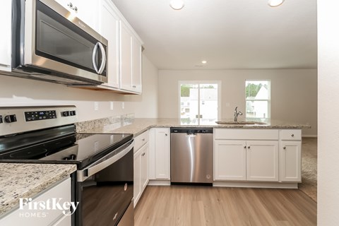 A kitchen with a stove top oven and microwave above it.