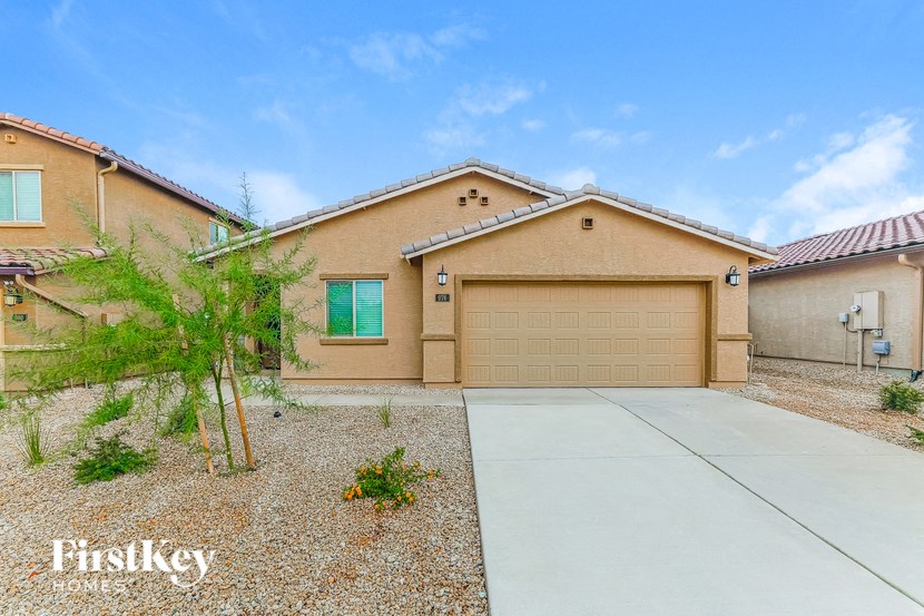 a beige house with a garage and a driveway