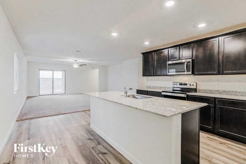 a kitchen with black cabinets and a white counter top