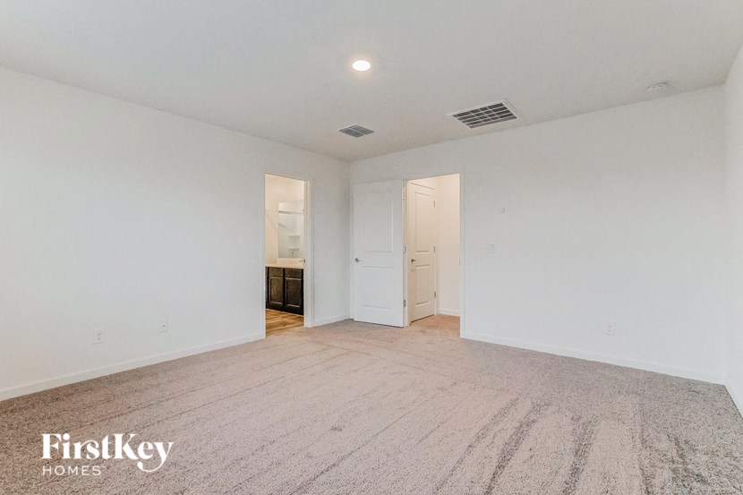 a renovated living room with white walls and wood flooring