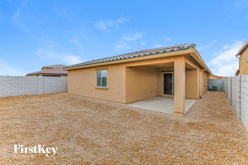 a house with a gravel yard and a garage
