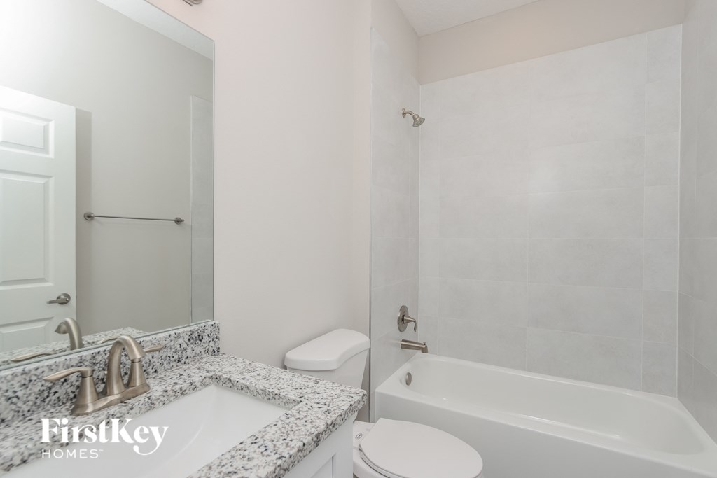 a bathroom with a sink and a toilet and a shower