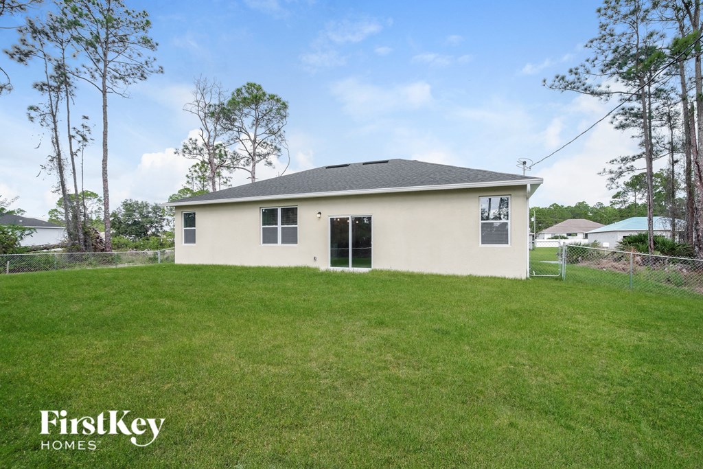 the front of the house with a big grassy yard
