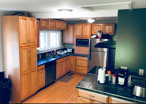 a kitchen with wooden cabinets and stainless steel appliances