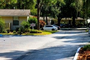A white car is parked on the side of a street.