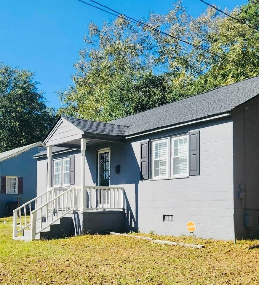 a white house with a white deck and a blue house