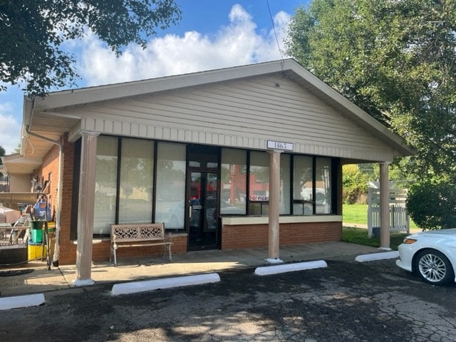 the front of a building with a bench in front of it