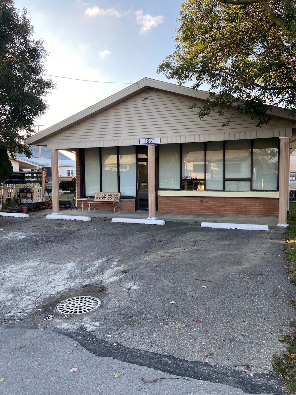 the front of a building with a parking lot