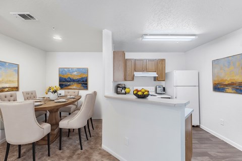 A dining room with a table set for four.