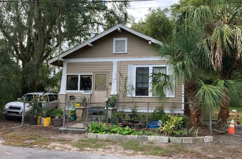 a small house with a garden in front of it