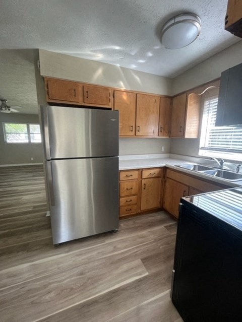 a kitchen with a stainless steel refrigerator and wooden cabinets