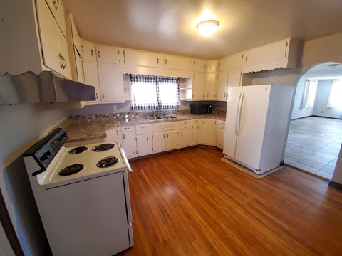 A kitchen with a stove and cabinets.