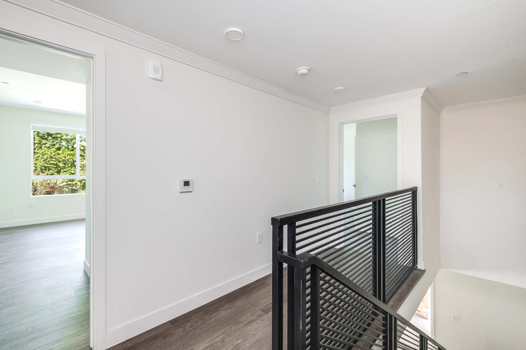 a view of the top of a staircase in a home with white walls