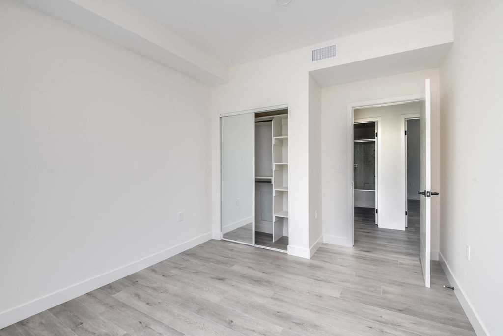 a living room with white walls and a wood floor