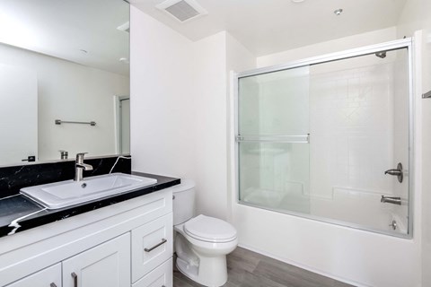 a bathroom with a sink toilet and a shower