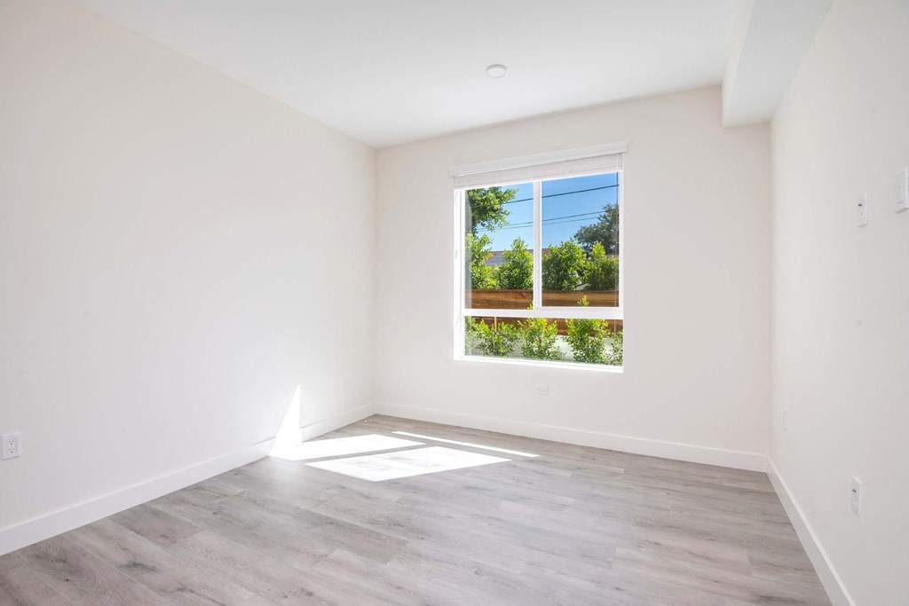 an empty room with white walls and a window