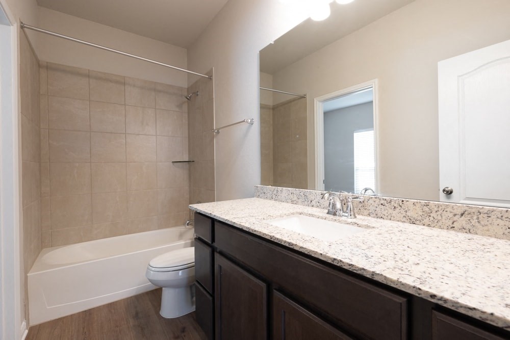 a bathroom with a sink and a toilet and a shower