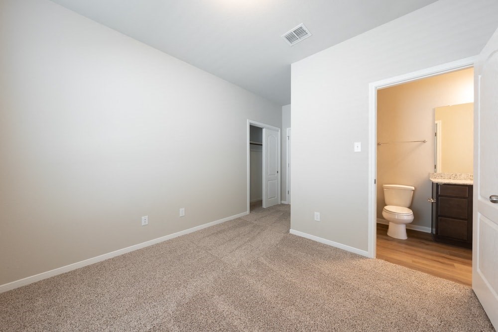 a bathroom with a toilet and a sink in a room