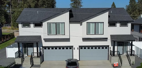 a white house with a car parked in front of it