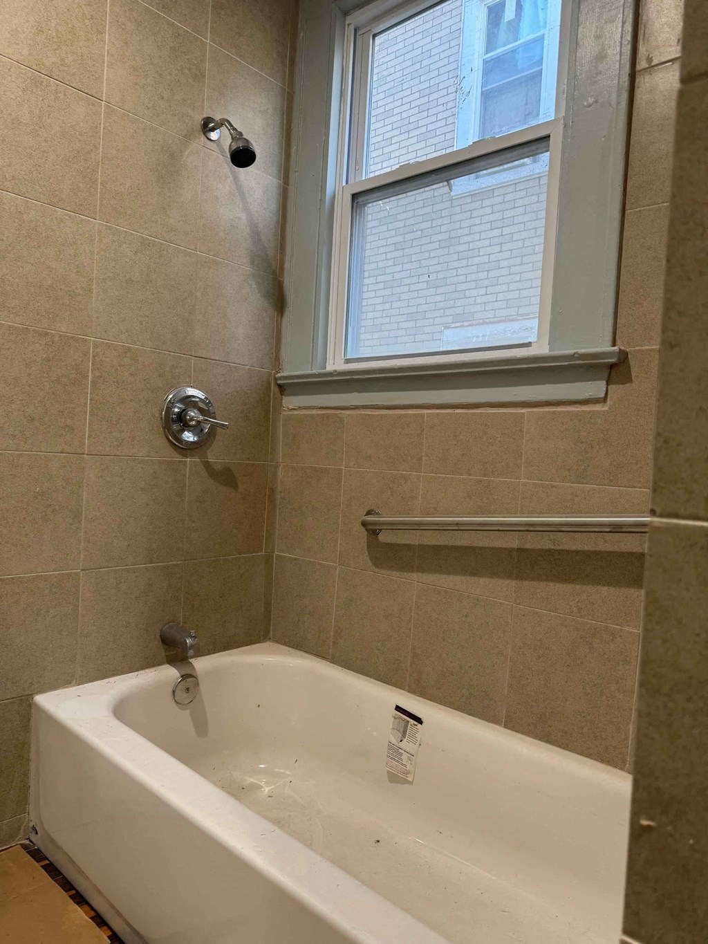 a bathroom with a tub and a window